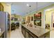 Open kitchen with large island, dining area, stainless appliances, and modern fixtures; ideal for entertaining at 3681 Divot Ln, Sarasota, FL 34232