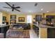 An elegant living room featuring a piano, ceiling fan, comfortable seating, and stylish decor at 3681 Divot Ln, Sarasota, FL 34232
