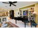 Spacious living area showcasing a piano, open layout, and access to the kitchen at 3681 Divot Ln, Sarasota, FL 34232