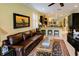 Inviting living room with a comfortable sofa, piano, and easy access to the open kitchen at 3681 Divot Ln, Sarasota, FL 34232