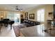 Inviting living space blending modern style with comfort, featuring a piano, plush seating, and bright natural light at 3681 Divot Ln, Sarasota, FL 34232