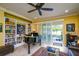 Living room features a piano and custom built-in bookshelves, adding character and storage at 3681 Divot Ln, Sarasota, FL 34232