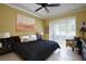The main bedroom has a ceiling fan, sliding door to the lanai and a tray ceiling at 3681 Divot Ln, Sarasota, FL 34232
