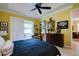 The spacious main bedroom has an upholstered armchair, sliding doors to the lanai, and decor at 3681 Divot Ln, Sarasota, FL 34232