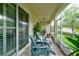 Covered patio with outdoor seating and a serene view of the landscaped backyard at 3681 Divot Ln, Sarasota, FL 34232