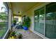 This screened patio has brick pavers, comfortable seating, and sliding glass doors to the interior at 3681 Divot Ln, Sarasota, FL 34232