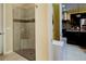 Contemporary glass-enclosed shower with tiled walls, a built-in seat, and a sleek design at 3681 Divot Ln, Sarasota, FL 34232