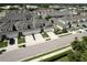 Street view of newer homes with paver driveways, two-car garages, and nicely manicured lawns at 3681 Divot Ln, Sarasota, FL 34232
