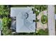 Aerial view of a luxurious home, showcasing the roof, pool, landscaping, and driveway at 413 Partridge Cir, Sarasota, FL 34236