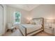 Cozy bedroom featuring a comfortable bed, stylish chair, and a large window for natural light at 413 Partridge Cir, Sarasota, FL 34236
