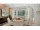 Bright dining room with decorative chandelier, designer touches, and serene views of the screened pool at 413 Partridge Cir, Sarasota, FL 34236