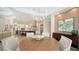 Contemporary dining area open to a kitchen with an island and breakfast bar seating and pendant lights at 413 Partridge Cir, Sarasota, FL 34236