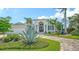 Stunning front view of property, showcasing lush landscape, circular driveway and entryway at 413 Partridge Cir, Sarasota, FL 34236