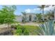 Attractive home featuring well-manicured landscaping, a circular driveway, and an elegant entrance with columns at 413 Partridge Cir, Sarasota, FL 34236