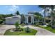 Beautiful home with lush landscaping, a circular driveway, and a stately front entrance at 413 Partridge Cir, Sarasota, FL 34236