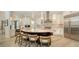 Spacious kitchen with a large center island with seating and stainless steel appliances and natural stone backsplash at 413 Partridge Cir, Sarasota, FL 34236