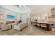 Open-concept living room connects to kitchen with bar seating; grand piano sits by fireplace at 413 Partridge Cir, Sarasota, FL 34236