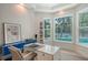 Office space with bright natural light from surrounding windows overlooking the backyard and pool at 413 Partridge Cir, Sarasota, FL 34236