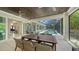 Charming outdoor dining area under a covered patio, featuring a wood-paneled ceiling and views of the pool at 413 Partridge Cir, Sarasota, FL 34236