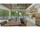 Outdoor dining area with a built-in kitchen featuring stainless steel appliances and a grill at 413 Partridge Cir, Sarasota, FL 34236