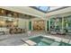 Outdoor kitchen and dining area with spa, seating area, and stainless steel appliances at 413 Partridge Cir, Sarasota, FL 34236