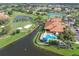 Aerial view showcasing the community clubhouse, pool, and golf course at 4211 Caddie E Dr # 202, Bradenton, FL 34203