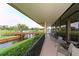 Balcony with tables and chairs overlooking water feature at 4211 Caddie E Dr # 202, Bradenton, FL 34203