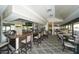 Inviting bar area featuring counter seating, mirrored accents, and views of the dining room at 4211 Caddie E Dr # 202, Bradenton, FL 34203