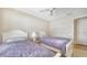 Bright bedroom featuring twin beds with coordinated bedding and a ceiling fan for added comfort at 4211 Caddie E Dr # 202, Bradenton, FL 34203
