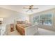 Comfortable bedroom with a ceiling fan, large window with bright natural light and relaxing pond views at 4211 Caddie E Dr # 202, Bradenton, FL 34203
