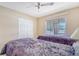 Cozy bedroom with twin beds, a closet, and a window letting in natural light at 4211 Caddie E Dr # 202, Bradenton, FL 34203