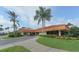 Exterior of the community clubhouse with landscaping and palm trees at 4211 Caddie E Dr # 202, Bradenton, FL 34203