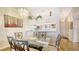 Charming dining area with a glass table, decorative chandelier, and views into the kitchen at 4211 Caddie E Dr # 202, Bradenton, FL 34203