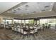 Bright dining area with large windows offering scenic views, complemented by ample seating arrangements at 4211 Caddie E Dr # 202, Bradenton, FL 34203