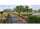 Scenic view of a golf course featuring a charming bridge over a tranquil lake, with beautiful greenery at 4211 Caddie E Dr # 202, Bradenton, FL 34203