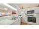Well-maintained kitchen featuring stainless steel appliances and white countertops, with a view to the living area at 4211 Caddie E Dr # 202, Bradenton, FL 34203