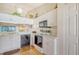 Efficient kitchen featuring white cabinets, and appliances, with views to the dining area at 4211 Caddie E Dr # 202, Bradenton, FL 34203
