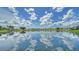 Scenic view of the lake with a clear reflection of the sky and surrounding community at 4211 Caddie E Dr # 202, Bradenton, FL 34203