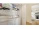 A bright laundry room with a washer, dryer, and shelving, conveniently located near the kitchen at 4211 Caddie E Dr # 202, Bradenton, FL 34203