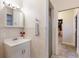 Bright bathroom featuring a vanity, mirror, tiled shower, and coordinated fixtures at 4232 Pandora Rd, Venice, FL 34293