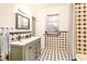 Bathroom featuring a tiled shower, gray vanity, and stylish sink at 4232 Pandora Rd, Venice, FL 34293