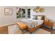 Modern bedroom with neutral tones, wooden accents, and large windows at 4232 Pandora Rd, Venice, FL 34293