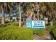 Sign for Venice Beach, with tropical landscaping and clear blue skies at 4232 Pandora Rd, Venice, FL 34293