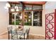 Bright dining room with a modern chandelier and large windows overlooking the front yard at 4232 Pandora Rd, Venice, FL 34293