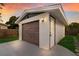 Garage exterior with a brown door and tasteful outdoor lighting at 4232 Pandora Rd, Venice, FL 34293