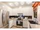 Well-lit kitchen with white cabinets, stainless steel appliances, and tile backsplash at 4232 Pandora Rd, Venice, FL 34293