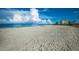 Expansive sandy beach featuring distant condos, clear sky, and ocean views at 4232 Pandora Rd, Venice, FL 34293
