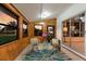 Cozy sunroom with wood paneled walls, large windows, and comfortable seating area at 4232 Pandora Rd, Venice, FL 34293