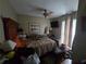 Bedroom with a ceiling fan, television, wood floors, and natural light from the window at 4343 Arrow Ave, Sarasota, FL 34232