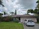 Charming single-story home with lush landscaping, a well-manicured lawn, and a private driveway at 4343 Arrow Ave, Sarasota, FL 34232